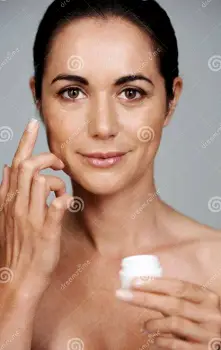 Adult applying moisturizer to the hand