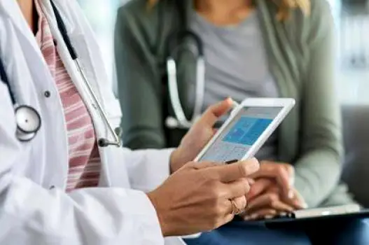Adult reviewing health information with a notebook and a glass of water