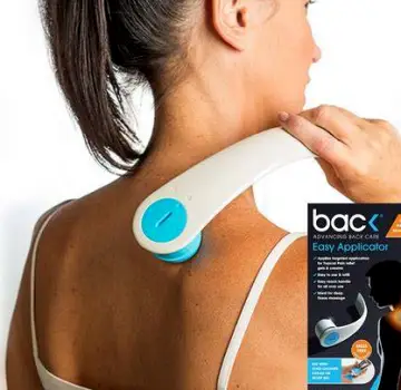 Person applying a small amount of clear topical treatment gel to their upper back and shoulder using their fingertips.