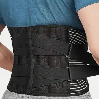 Hands adjusting a back brace strap on a person's waist, with the support positioned between the pelvis and rib cage
