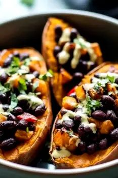 Baked sweet potato split open and topped with black beans and salsa