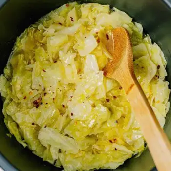 Three preparations of cabbage: raw shredded cabbage in a bowl for slaw, cooked cabbage wedges softened by steaming or roasting, and fermented cabbage as sauerkraut in a jar and kimchi in a small dish