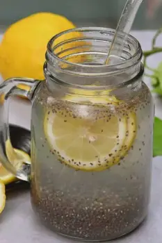 Glass of water containing soaked chia seeds and a slice of lemon, representing the 'internal shower' chia drink