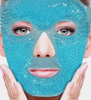 Person applying a cloth-wrapped ice pack to the cheek
