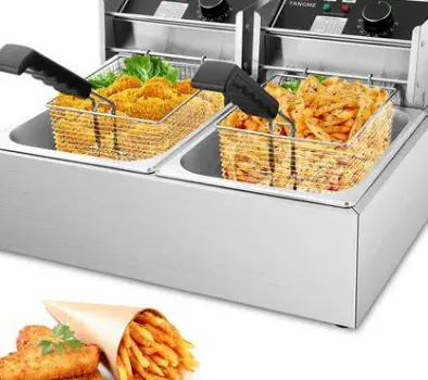 Basket of french fries cooking in a commercial deep fryer, showing the shared oil.