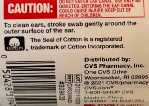 A clean human ear next to a cotton swab, highlighting that cotton swabs should not be inserted