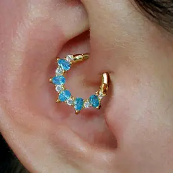 Close-up of an ear showing a daith piercing in the innermost fold of cartilage near the ear canal