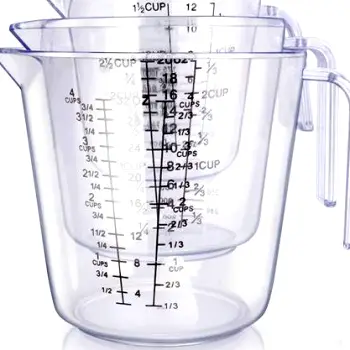 A calibrated measuring cup filled with liquid dicyclomine medication beside a bottle