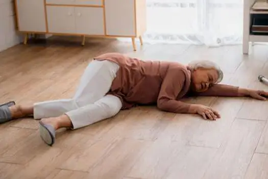 Elderly woman stumbling on sidewalk