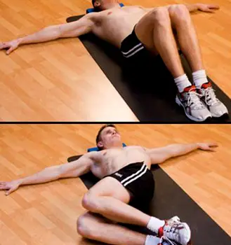 Person lying on back with knees bent, slowly rocking knees side to side