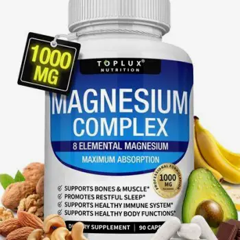 Close-up of magnesium supplement capsules spilling from a white bottle