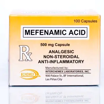 A person taking a mefenamic acid tablet with food