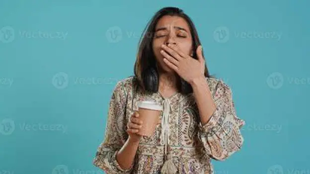 Person yawning, showing possible drowsiness after taking an antihistamine