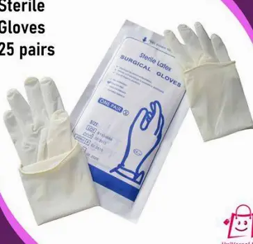 Piercer wearing gloves preparing sterile single-use needles on a clean studio workspace