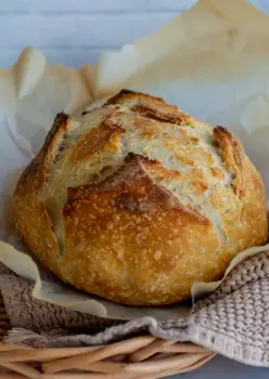 Freshly baked sourdough loaf with a pale, slightly cracked crust