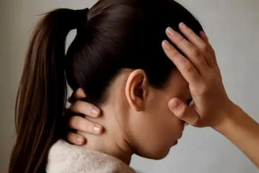 Back view of a person with hair pulled tightly into a ponytail, with the hairline drawn taut