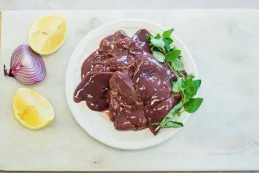 A whole human liver shown beside a portion of liver tissue against a neutral background