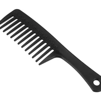 Hand using a wide-tooth comb to detangle damp, conditioner-coated hair strands