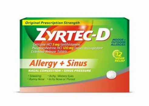 A blister pack of Zyrtec-D tablets with an unmarked white pill pushed partly out